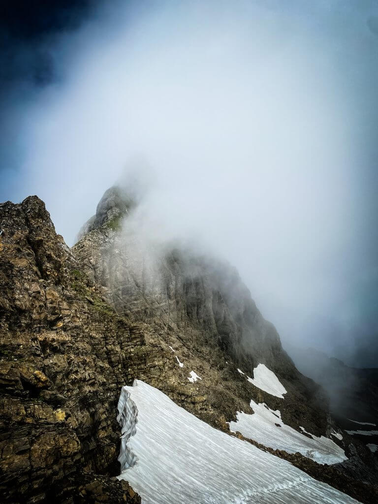 Misty alpine ridge with snow