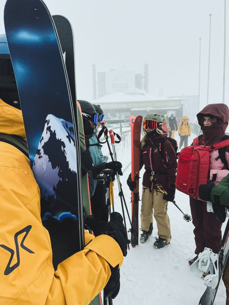 Skiers standing with skis having conversation