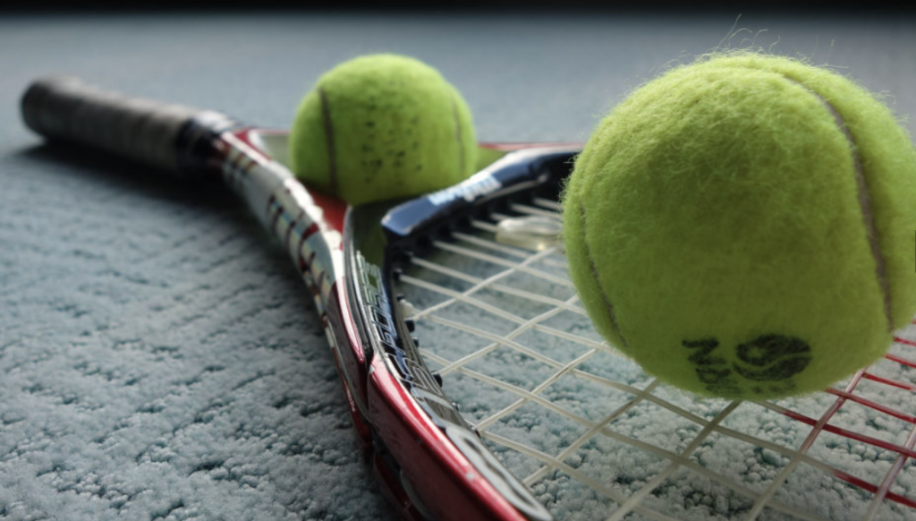 Tennis racket with two tennis balls